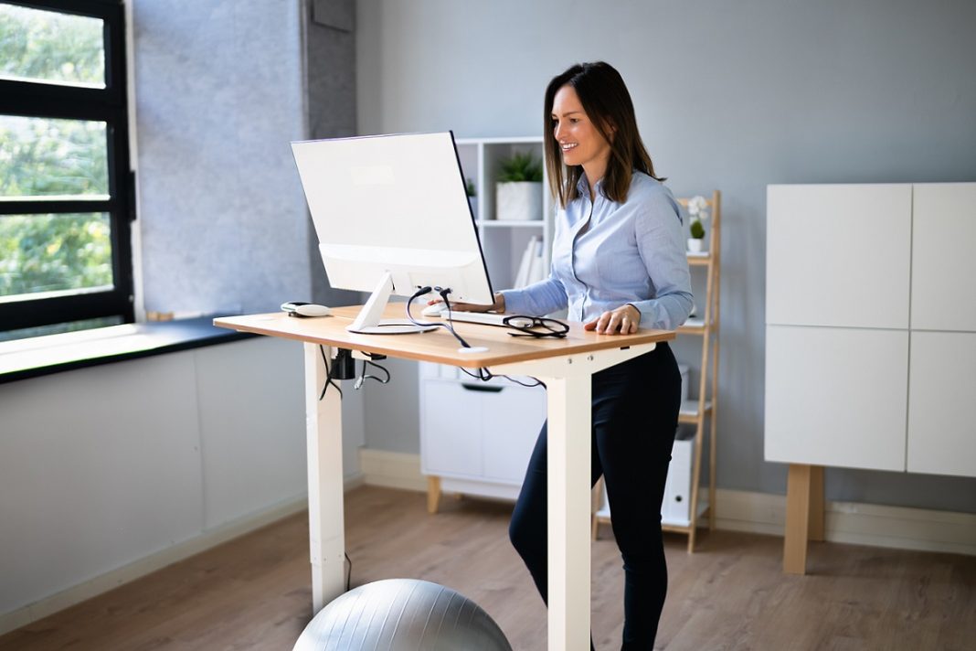 Woman using an adjustable standing desk